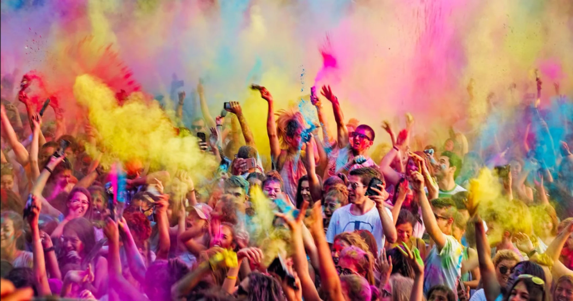 People of all ages dancing to the rhythm of Holi songs, embodying the festival's spirit of unity and joy in 2024