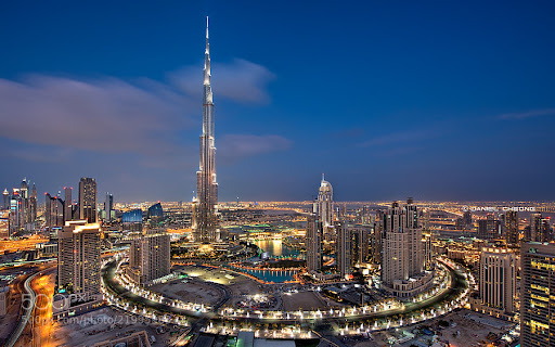 The bustling Dubai Mall, filled with shoppers and iconic stores, set against a backdrop of modern architecture. 