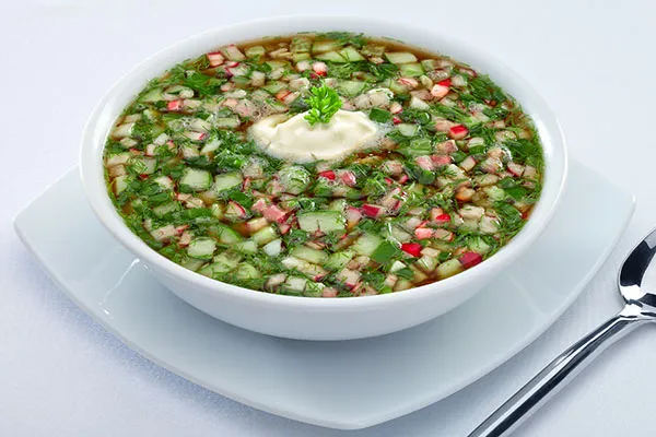 Chilled Okroshka with kvass base and colorful vegetables. 