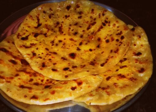 Golden Bobbatlu served warm with a drizzle of ghee