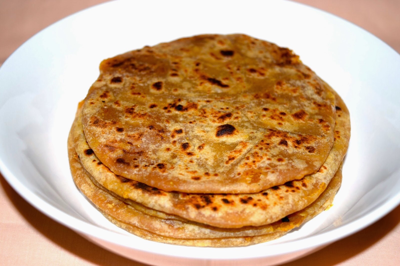 Close-up of soft Bobbatlu filled with sweet jaggery and lentils 