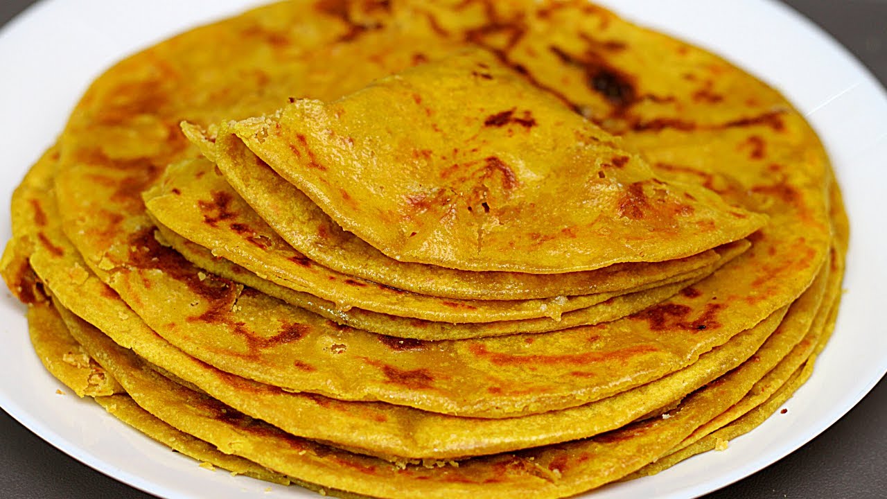 Bobbatlu being cooked on a griddle to golden perfection 